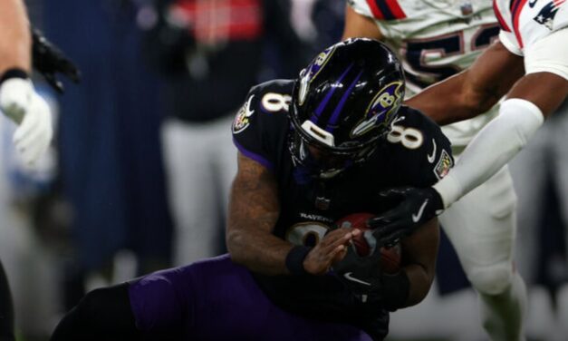 Lamar injures back in loss to Patriots